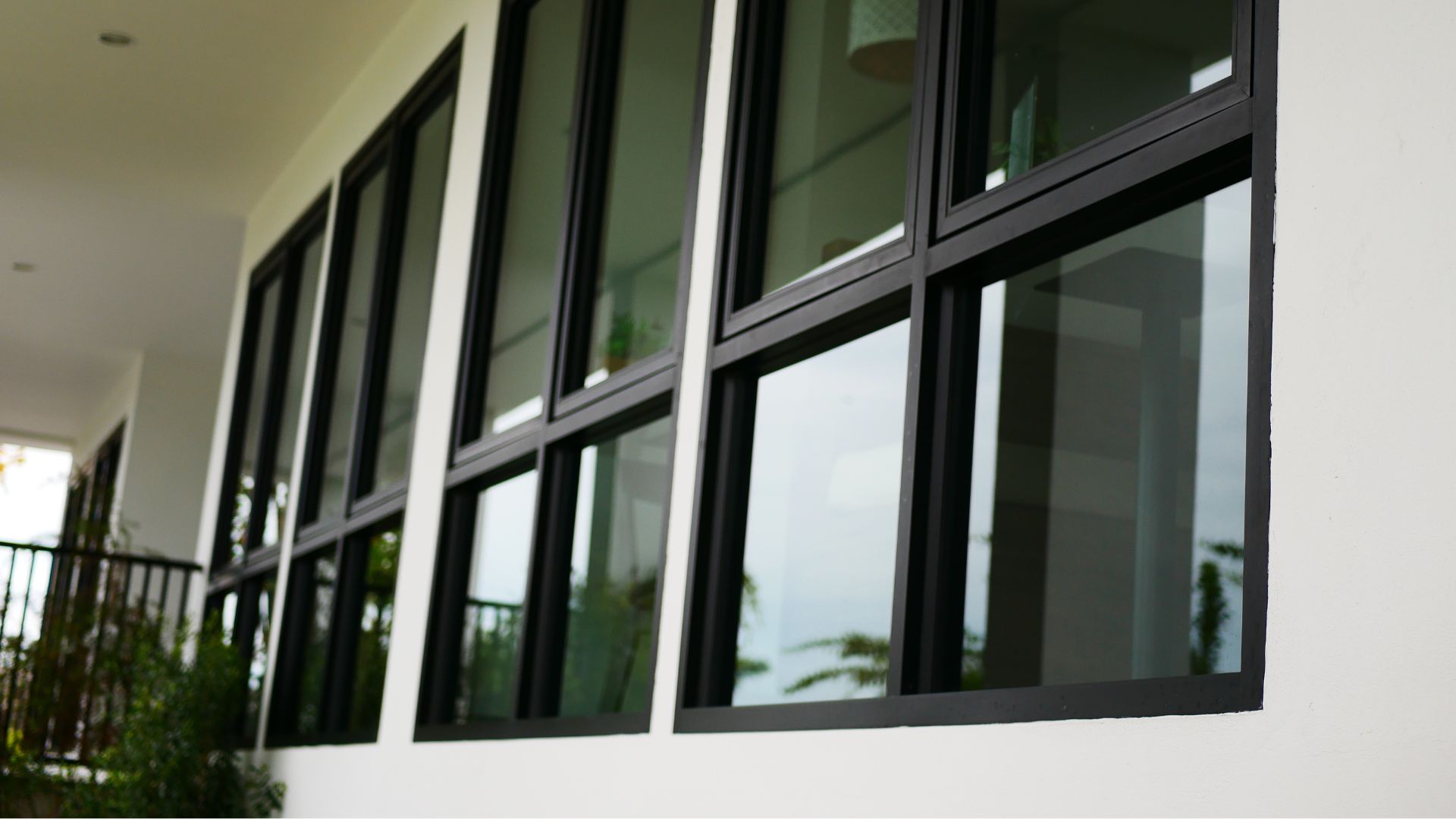 Modern black-framed windows on a white building.