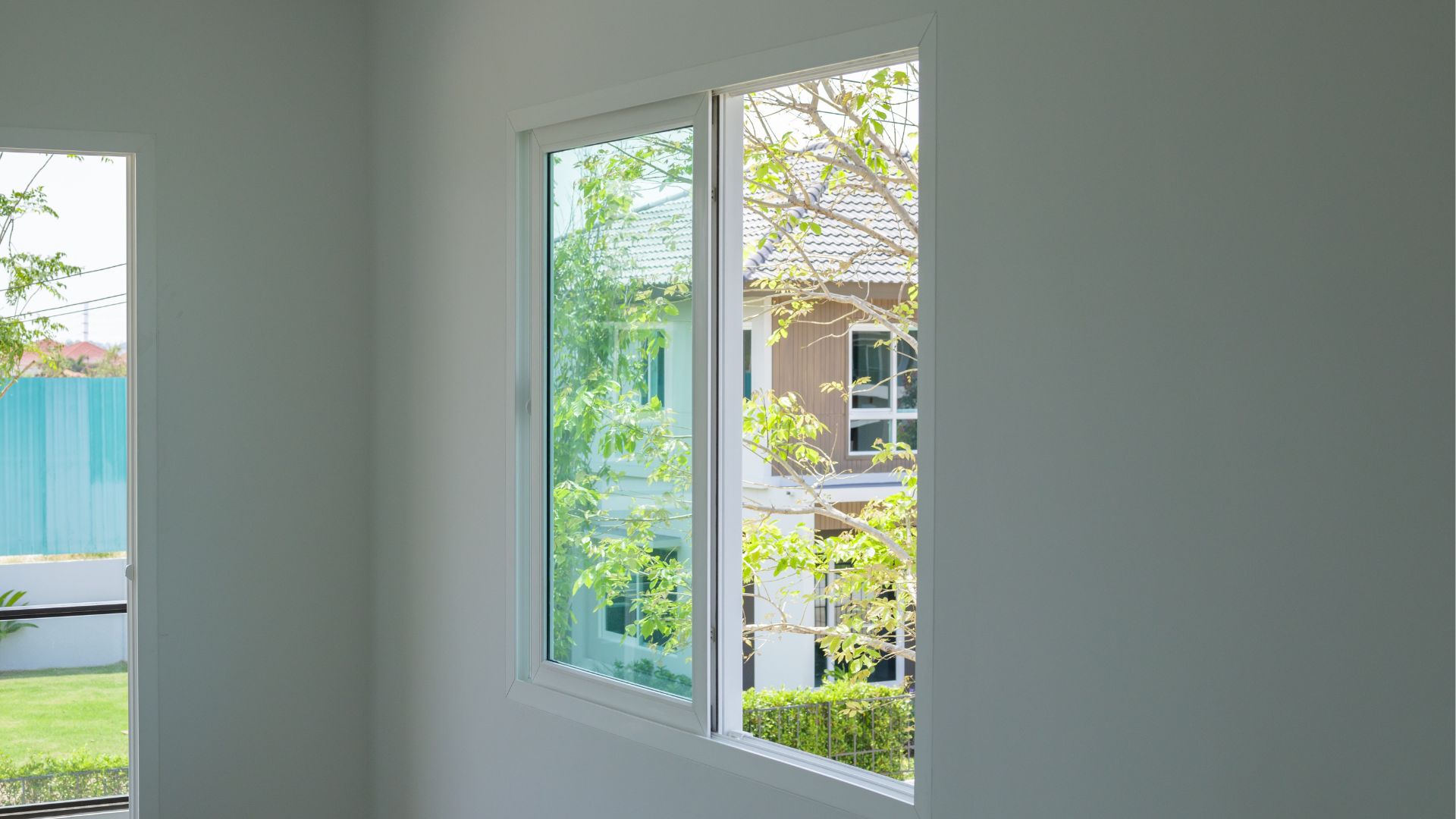 Sliding glass window overlooking a garden.